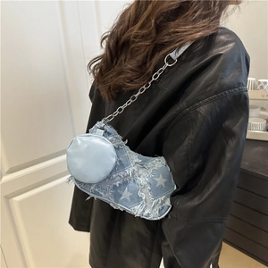 Blue denim shoulder bag with white stars, fringe detail and side coin purse charm