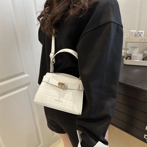 White crocodile embossed leather crossbody handbag with gold hardware and handle