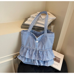 Detail of blue gingham tote bag showing double-layered ruffles and drawstring closure