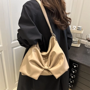 Chic beige bow shoulder bag for women with large ribbon detail and spacious casual design