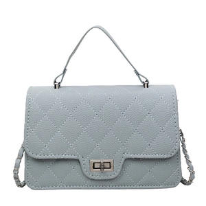 Light blue quilted leather crossbody bag with chain strap and silver twist lock closure