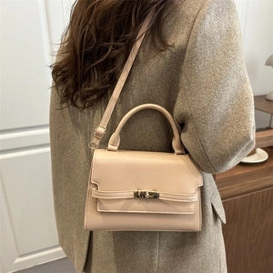 Beige leather crossbody square bag with top handle and metallic buckle lock