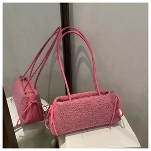 Detail of pink faux fur crossbody phone bag with fluffy texture and side drawstring