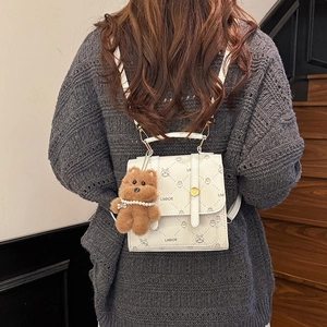 Chic beige quilted backpack for women with cute bear charm and 'LNBOE' print design