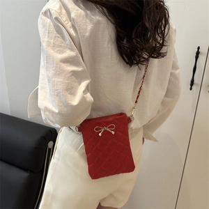 Fashionable red quilted shoulder bag with golden bow and metal chain strap for girls