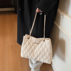 Women's beige quilted velvet tote bag with golden chain straps for fashion commuting
