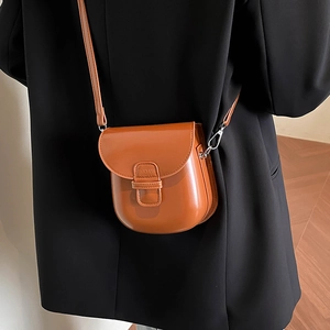 Caramel glossy leather mini crossbody bag with U-shape flap design and shoulder strap