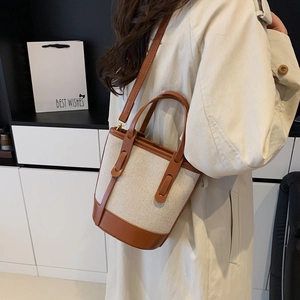 Fashionable contrast bucket bag in beige canvas and brown leather for women