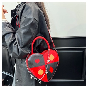 Détail du sac en forme de cœur avec motif poker, contraste rouge noir et chaîne argentée