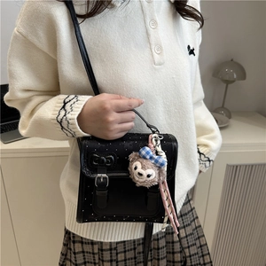 Black polka dot crossbody bag with a cute bow and plush bear charm for daily wear
