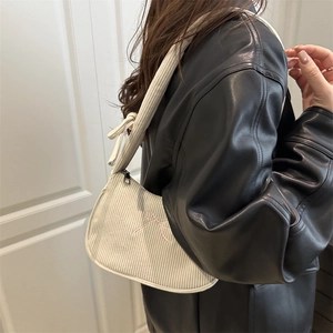 White corduroy underarm bag with pink embroidered bow detail for casual commuting