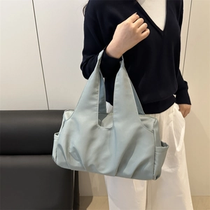 Light blue nylon fitness tote bag with pleated base and high capacity for sports