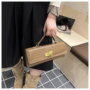 Brown crocodile pattern baguette handbag with gold twist lock and elegant top handle