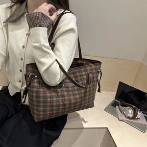 Large plaid bucket bag with brown leather trim and retro shoulder strap styling