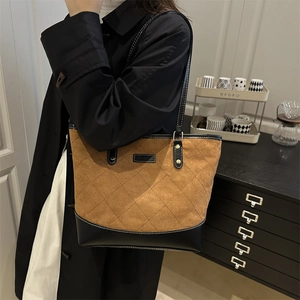 Retro brown suede quilted tote bag with black leather straps shown in lifestyle setting