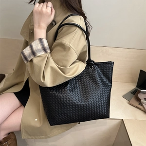 Minimalist black woven tote bag with Intrecciato texture and knotted leather handles