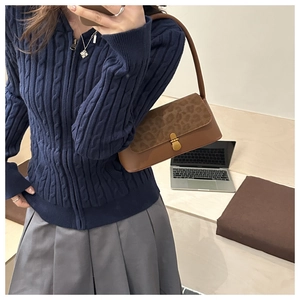 Mirror selfie showing a brown baguette bag with leopard print suede flap and metal clasp