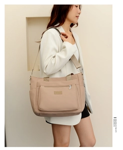 Detailed macro view of large capacity nylon tote with wide woven shoulder strap