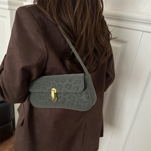 Minimalist dark leopard print underarm bag with gold oval clasp and sleek shoulder strap