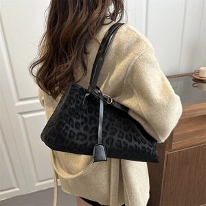 Large leopard print shoulder bag in black styled with a casual autumn beige coat