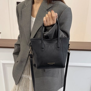 Elegant black leather crossbody bucket bag with gold hardware and top handles for women