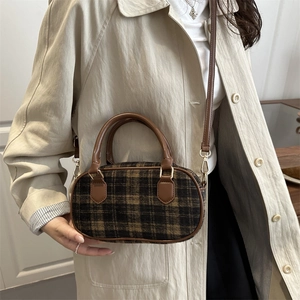 Leopard print wool shoulder bag with brown leather handles and gold metal hardware