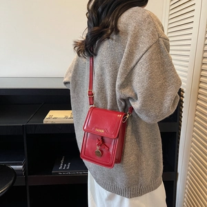 Red crossbody mini square bag with metallic ball pendant and adjustable strap for women