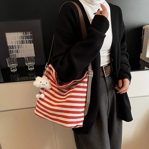 Red and white striped canvas tote bag with adjustable brown leather strap and cloud charm