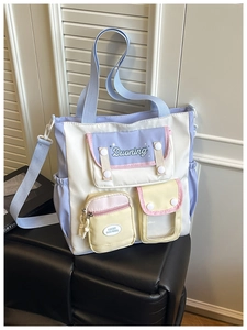 Detail view of colorful multi-pocket tote bag with adjustable strap and functional compartments