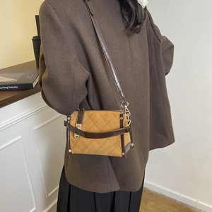 Quilted crossbody bag in brown suede with gold hardware and wide adjustable shoulder strap