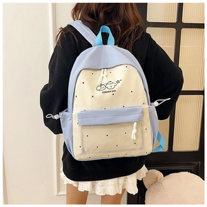 Detail view of the clear front pocket on a polka dot student backpack with dog pattern