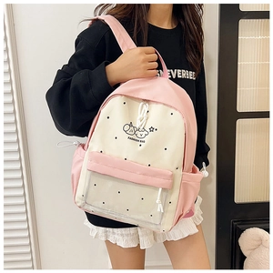 Detail of cute pink and cream school backpack with transparent pocket and polka dot decor