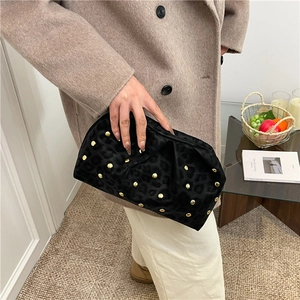 Fashionable black velvet dumpling bag with gold studs and leopard print texture