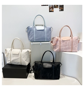Detail showing high-capacity travel bags in multiple colors with waterproof nylon texture