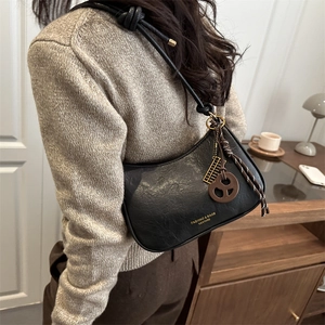 Retro black leather shoulder bag with knot strap and cookie pendant for women