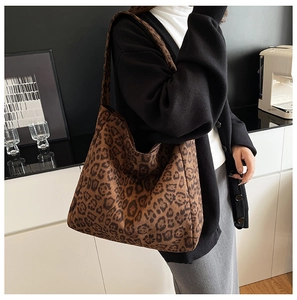 Detailed view of large capacity leopard print tote bag with faux suede texture on shoulder