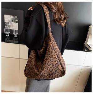 Detail of spacious leopard print tote bag in plush fabric with a slouchy minimalist design