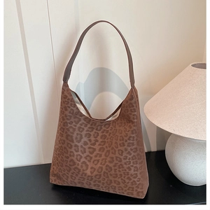 Close-up of vintage leopard print hobo bag with soft textured suede fabric and long strap