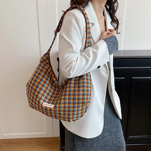 Fashionable colorful houndstooth plaid tote bag with spacious interior and woven tag