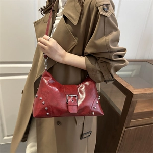 Dark red studded tote bag in oil wax leather with vintage silver buckle and Y2K aesthetic