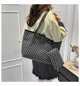 Detailed view of black geometric pattern tote bag and matching inner pouch set