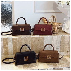 Detail of four square crossbody bags in brown, burgundy, and black with golden S-lock