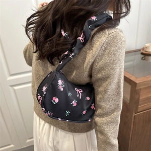 Sac sous le bras pour femme noir avec roses roses et motif de nœuds porté à l'épaule