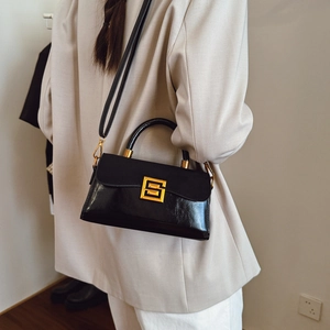 Retro black patent leather handbag with gold S-buckle and elegant shoulder strap