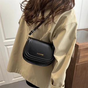 Chic black saddle crossbody bag with gold fashion lettering for 2025 autumn winter style
