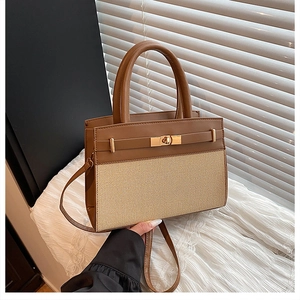 Detail of vintage patchwork handbag featuring brown leather trim and golden twist lock closure