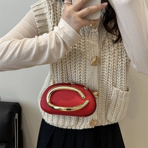 Classic red oval evening clutch bag with gold circular handle and metal chain strap