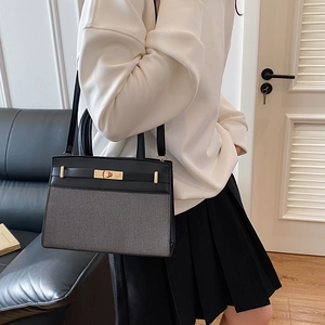 Chic black and gray patchwork Kelly-style handbag with gold hardware for women