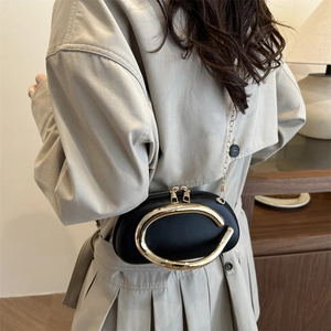Classic black leather evening clutch bag with large gold oval buckle and chain strap