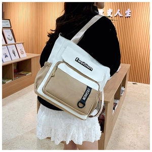 Detail view of large color-block canvas messenger bag with wide comfortable shoulder strap